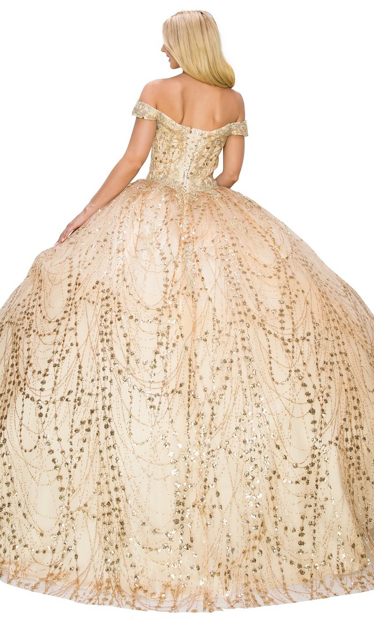 A woman stands facing away in the Quinceanera Ball Gown 8033J, featuring a gold off-the-shoulder design, lace-up back, a glittering ball gown skirt, and ornate sparkling details.